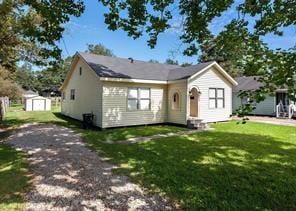 bungalow with an outdoor structure, a front yard, entry steps, and a storage unit