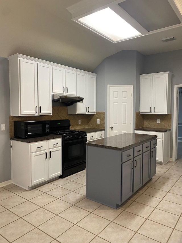 kitchen featuring under cabinet range hood, light tile patterned floors, visible vents, decorative backsplash, and black appliances
