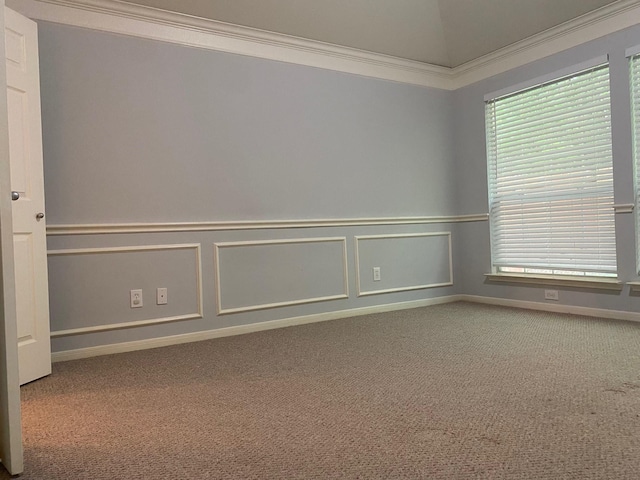 empty room with carpet floors, healthy amount of natural light, and crown molding