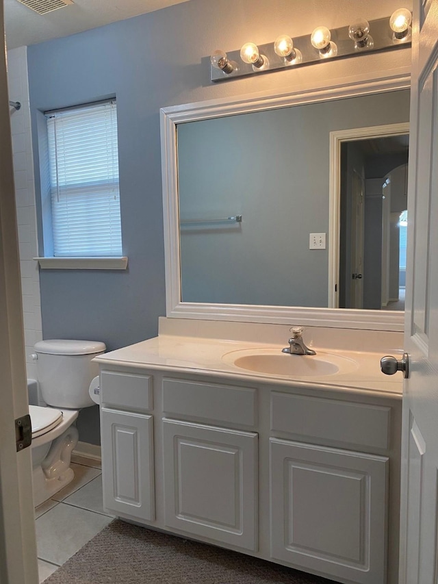bathroom featuring toilet, visible vents, tile patterned flooring, and vanity