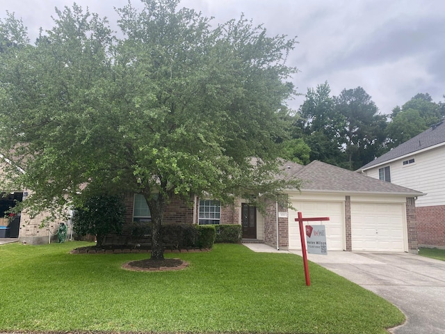 obstructed view of property featuring a garage, driveway, brick siding, and a front yard