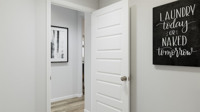 hallway with wood finished floors and baseboards