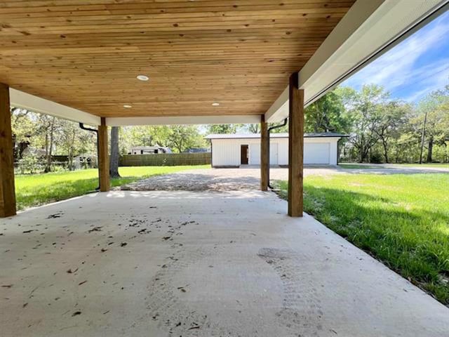 view of patio with an outbuilding and a carport