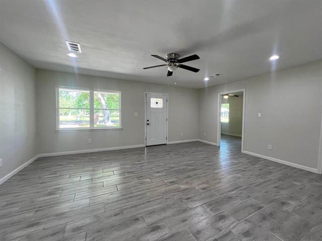 unfurnished living room featuring a ceiling fan, baseboards, and recessed lighting