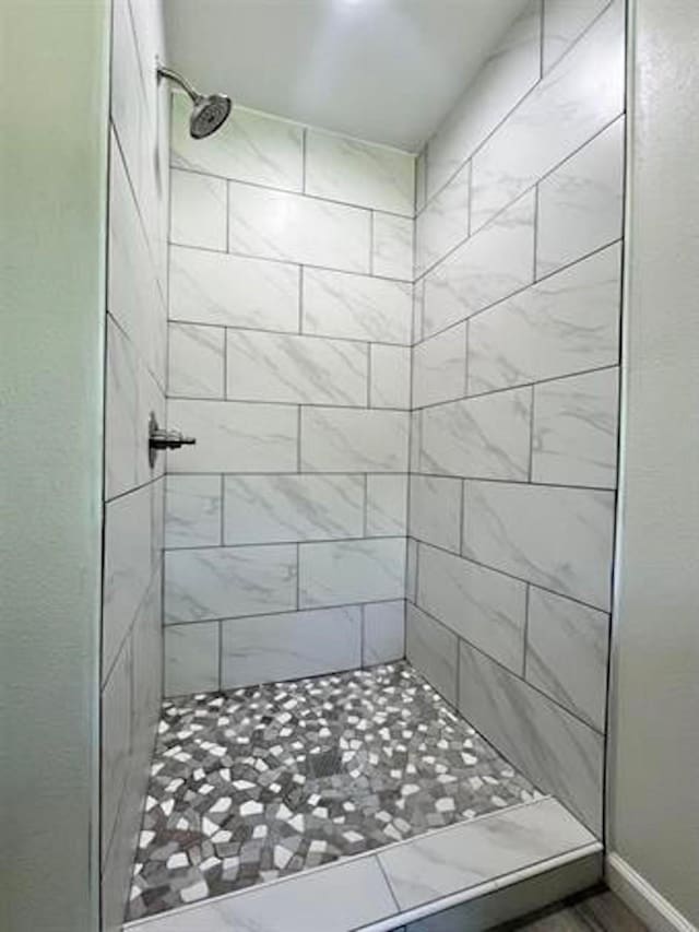full bathroom with tiled shower