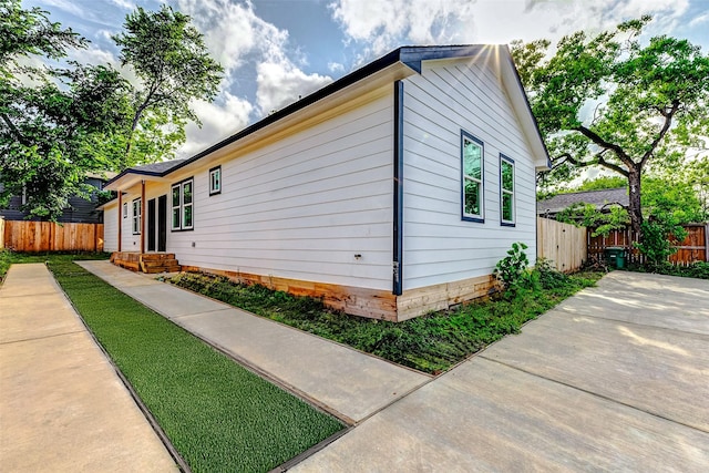 view of property exterior featuring fence