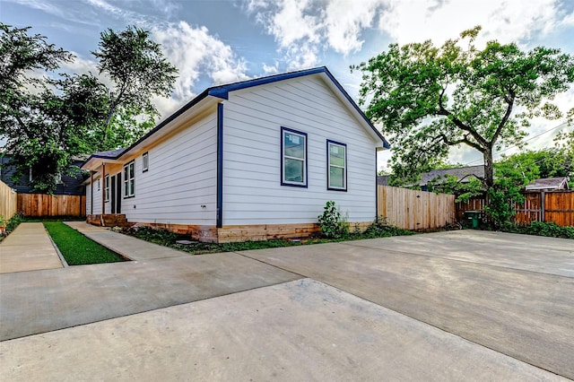 view of home's exterior featuring fence