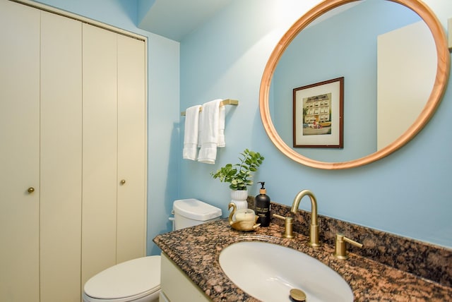 bathroom with toilet and vanity