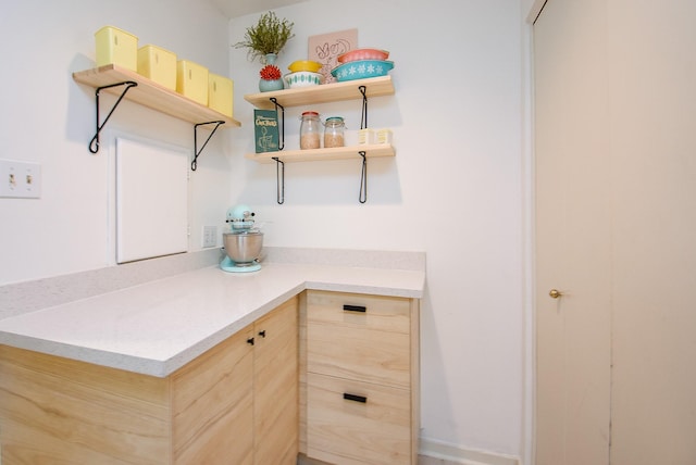 interior space with light countertops and light brown cabinetry