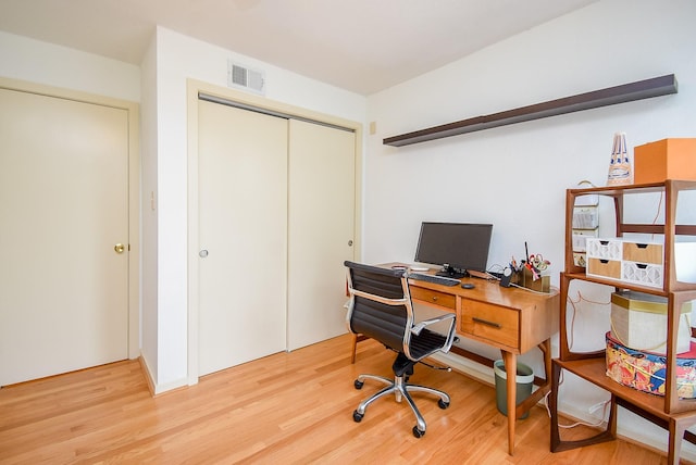 office area featuring visible vents and wood finished floors