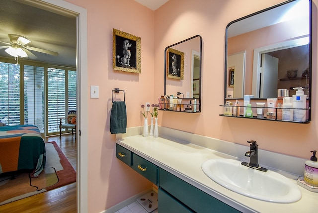 bathroom featuring wood finished floors, vanity, and ceiling fan