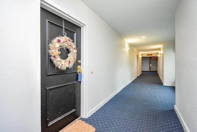 hallway with carpet and baseboards