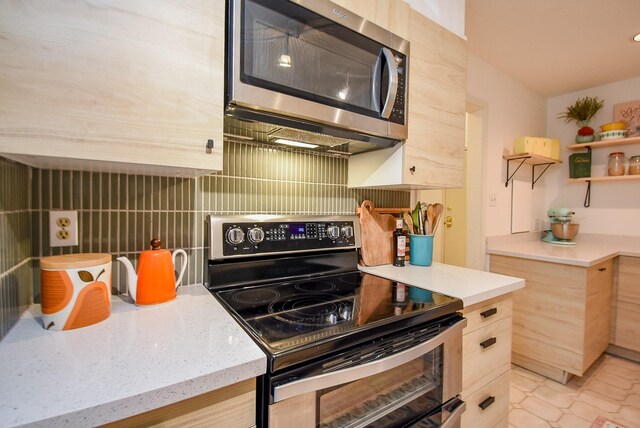 kitchen featuring light brown cabinets, modern cabinets, open shelves, decorative backsplash, and appliances with stainless steel finishes