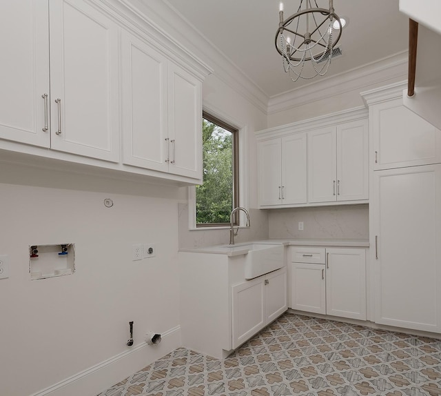 clothes washing area featuring gas dryer hookup, a chandelier, hookup for an electric dryer, crown molding, and washer hookup