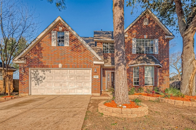 traditional-style house with roof with shingles, fence, brick siding, and driveway