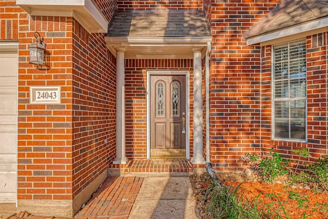 property entrance with brick siding