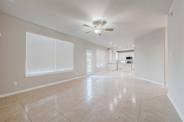 unfurnished living room with baseboards, a ceiling fan, light tile patterned floors, and recessed lighting