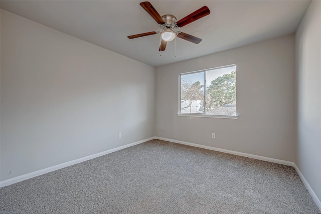 carpeted empty room with ceiling fan and baseboards