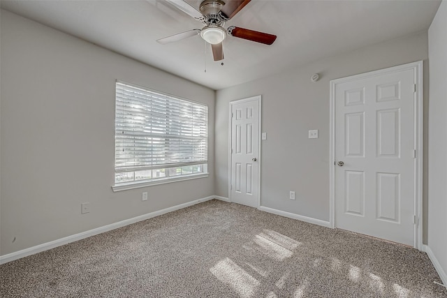 unfurnished bedroom featuring baseboards, a ceiling fan, and carpet floors