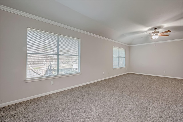 carpeted spare room featuring a ceiling fan, ornamental molding, lofted ceiling, and baseboards