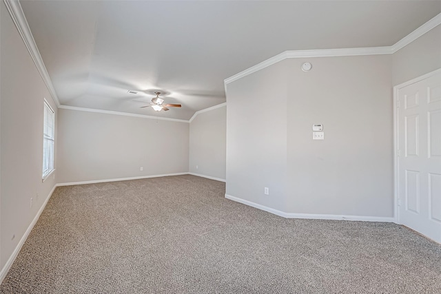 carpeted spare room with crown molding, baseboards, lofted ceiling, and ceiling fan