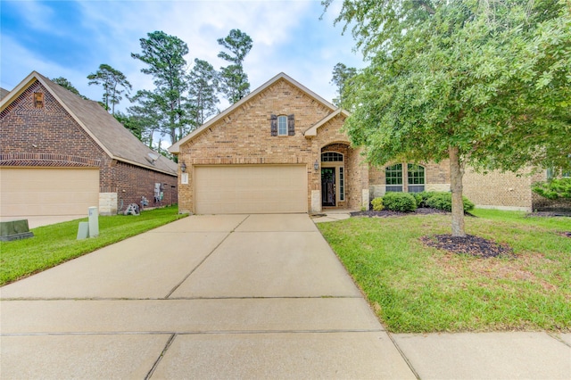 22526 Forbes Field Trl, Spring, TX 77389 - traditional home with concrete driveway, brick siding, and a front yard