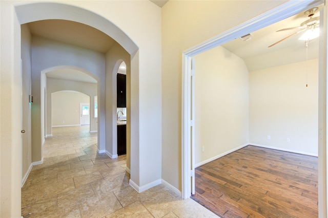 22526 Forbes Field Trl, Spring, TX 77389 - corridor with baseboards, stone finish flooring, and arched walkways