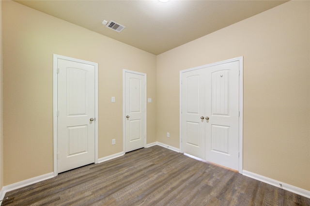 22526 Forbes Field Trl, Spring, TX 77389 - unfurnished bedroom with baseboards, dark wood-type flooring, and visible vents