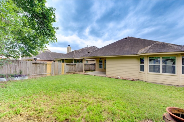 22526 Forbes Field Trl, Spring, TX 77389 - back of property with a fenced backyard, roof with shingles, a patio area, and a lawn