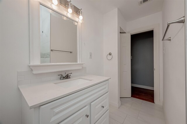 4811 Stillbrooke Dr, Houston, TX 77035 - bathroom featuring visible vents, baseboards, tasteful backsplash, marble finish floor, and vanity
