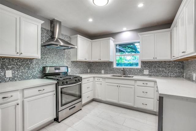 4811 Stillbrooke Dr, Houston, TX 77035 - kitchen featuring marble finish floor, a sink, white cabinetry, wall chimney exhaust hood, and stainless steel range with gas stovetop
