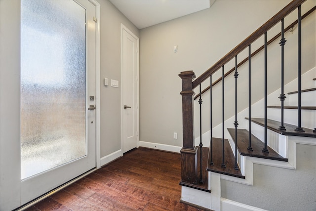 entrance foyer with baseboards, stairway, and wood finished floors
