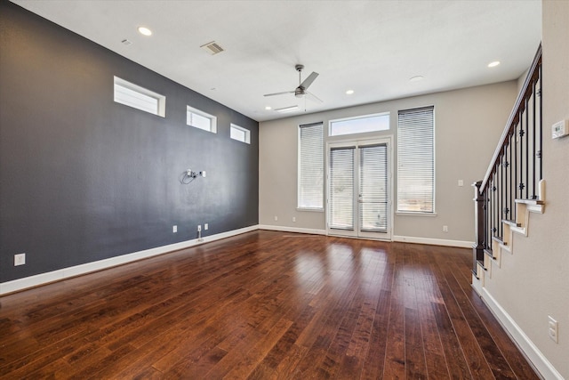 unfurnished living room with wood-type flooring, baseboards, a ceiling fan, and visible vents