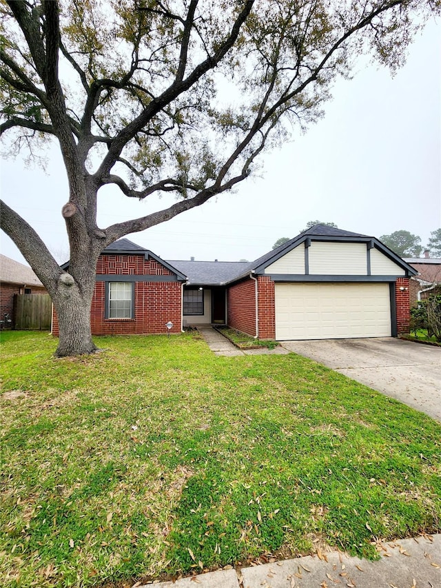 view of front of home featuring an attached garage, fence, a front lawn, brick siding, and driveway