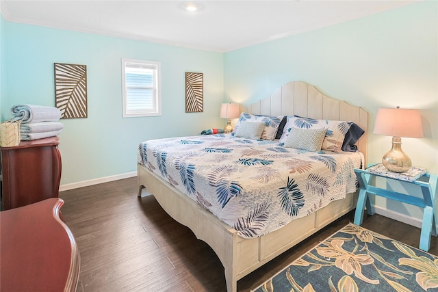 bedroom featuring baseboards and dark wood-style floors