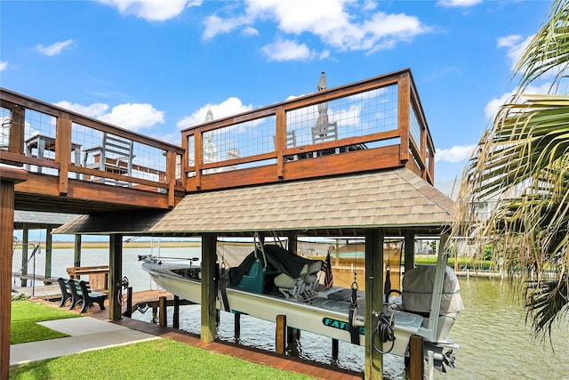 exterior space featuring a water view, roof with shingles, and boat lift