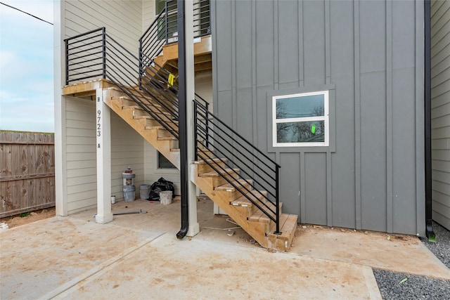 view of patio with stairway and fence