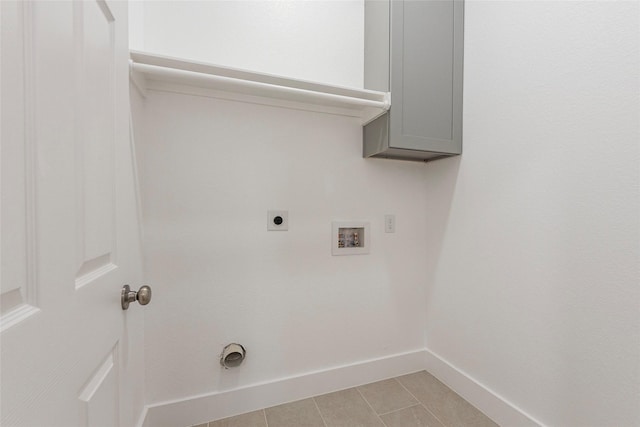 washroom with baseboards, light tile patterned floors, hookup for a washing machine, hookup for an electric dryer, and laundry area
