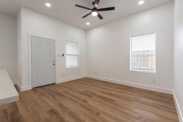 interior space with recessed lighting, baseboards, a ceiling fan, and wood finished floors
