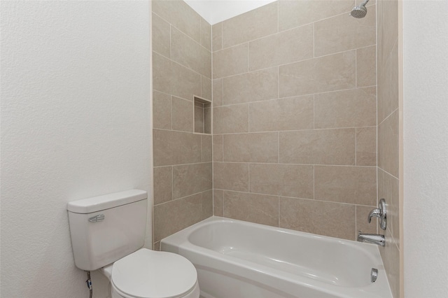 full bath with toilet, a textured wall, and shower / bathtub combination