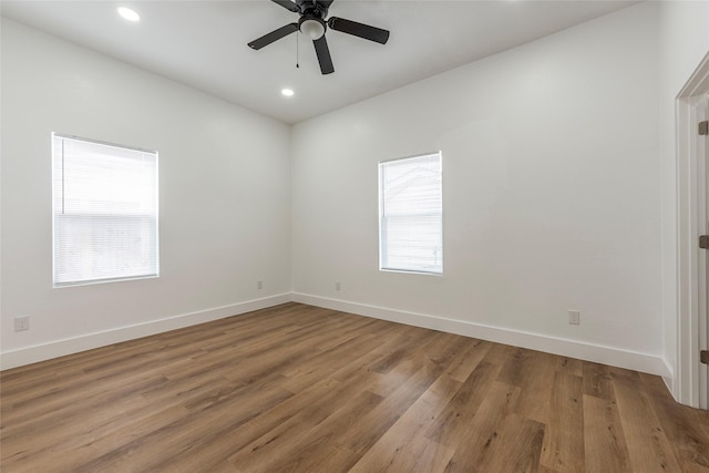 spare room with ceiling fan, recessed lighting, baseboards, and wood finished floors