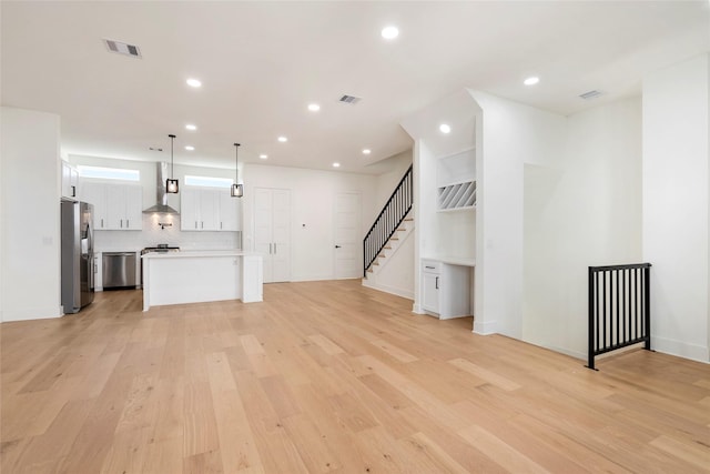 407 Grove St Unit B, Houston, TX 77020 - unfurnished living room with light wood finished floors, recessed lighting, and stairs