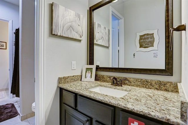 bathroom featuring vanity, toilet, and tile patterned flooring
