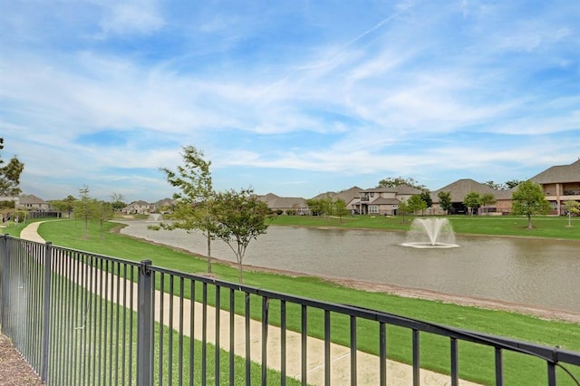 water view featuring fence and nearby suburban area