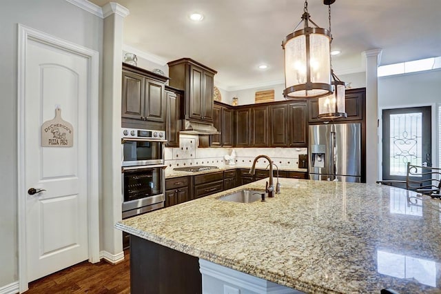 kitchen featuring stainless steel appliances, a sink, crown molding, dark brown cabinets, and decorative backsplash