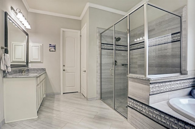 full bathroom featuring a shower stall, crown molding, baseboards, vanity, and a relaxing tiled tub