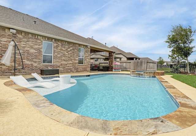 view of swimming pool with a fenced backyard, a pool with connected hot tub, and a patio