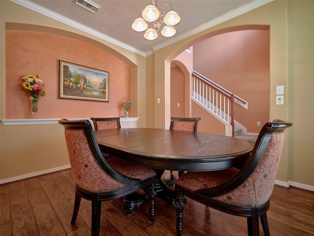 23623 Breckenridge Forest Dr, Spring, TX 77373 - dining room with a notable chandelier, baseboards, visible vents, arched walkways, and stairway