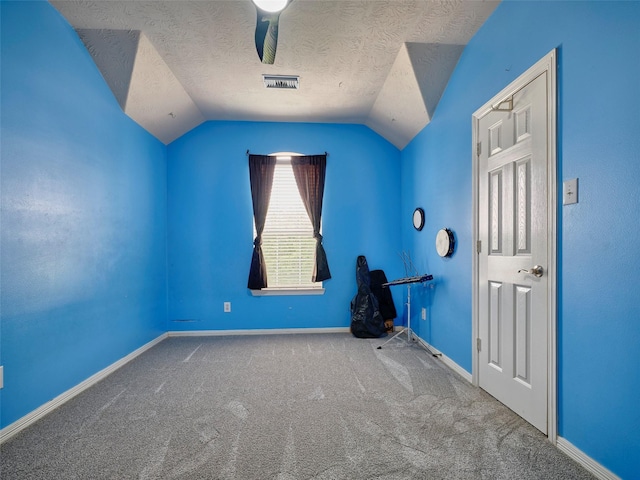 23623 Breckenridge Forest Dr, Spring, TX 77373 - interior space featuring a textured ceiling, carpet, baseboards, visible vents, and vaulted ceiling