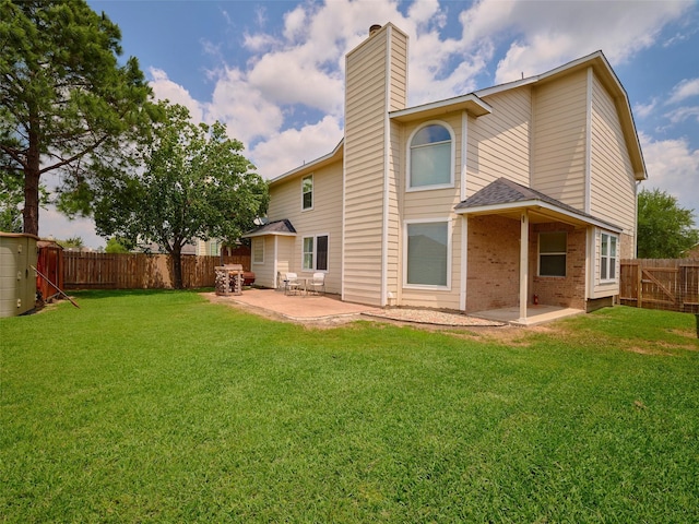 23623 Breckenridge Forest Dr, Spring, TX 77373 - rear view of property featuring a patio, a chimney, a lawn, a fenced backyard, and brick siding